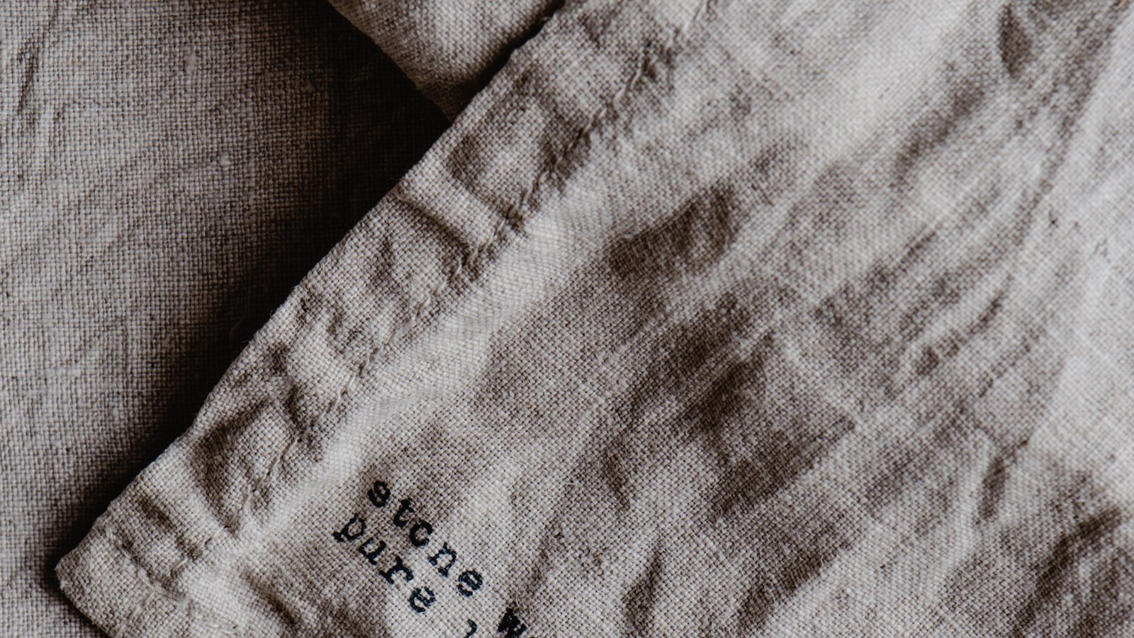 Neatly folded stack of bed linens and sheets ready for a rotation starter kit