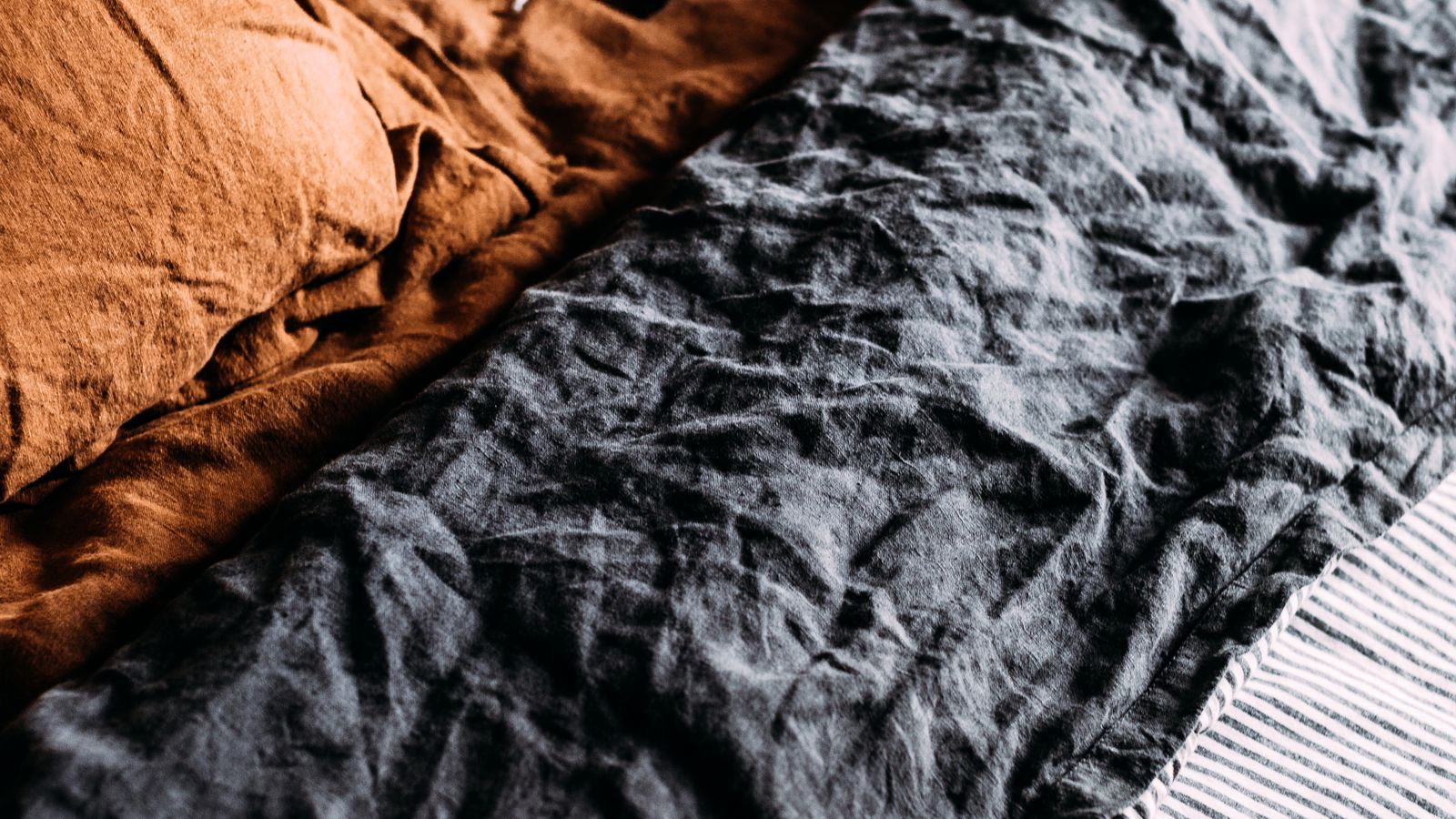 Fitted sheet being placed on a split king mattress with two separate halves
