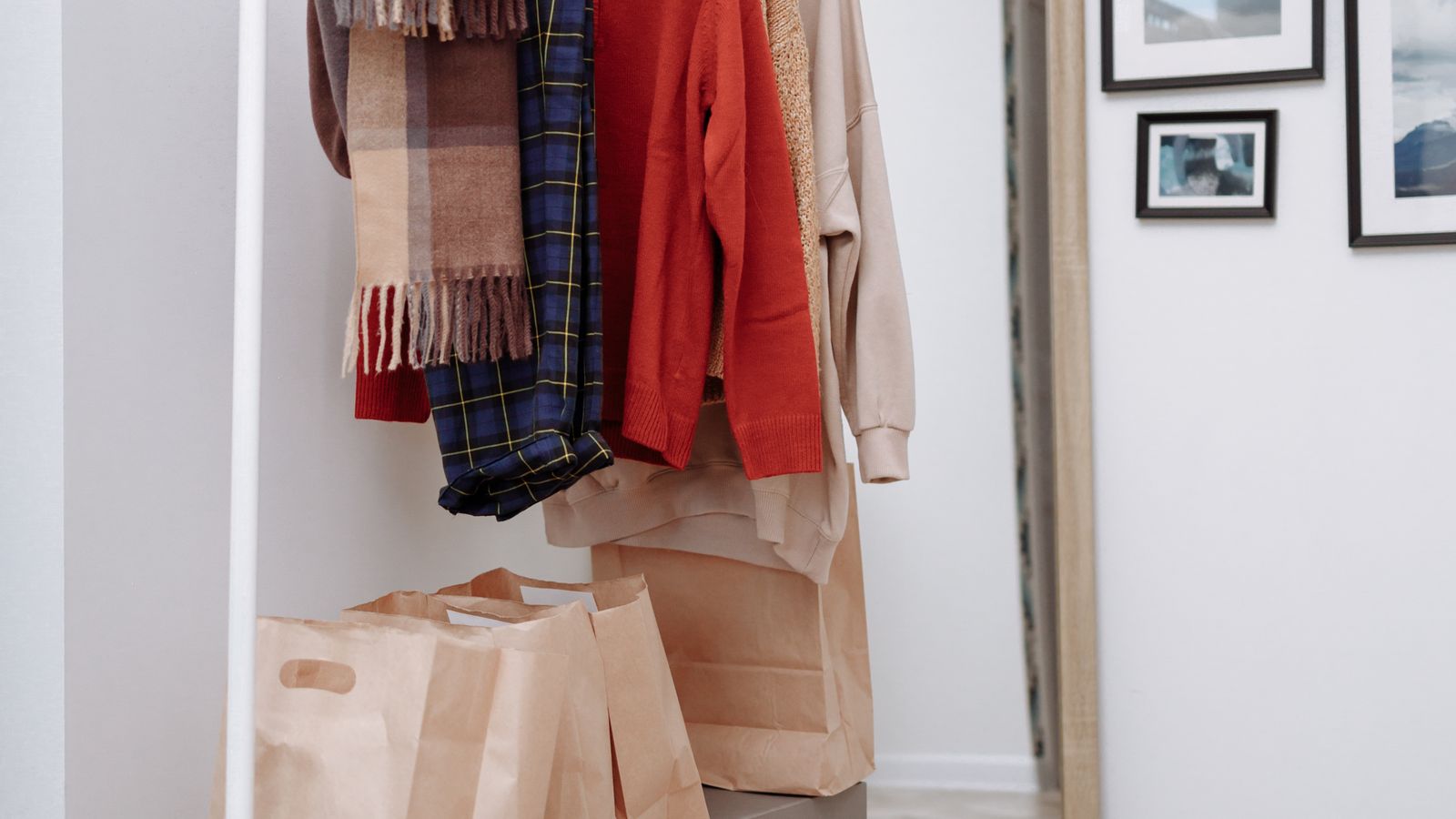 Stack of neatly folded bedding stored next to comforter storage bags