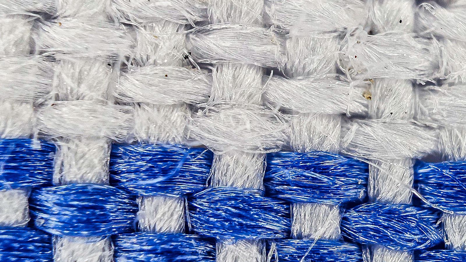 Close-up macro of blue and white waffle weave woven fabric texture