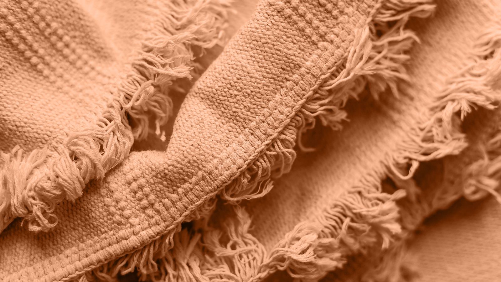Folded waffle weave blanket showing worn texture and edges