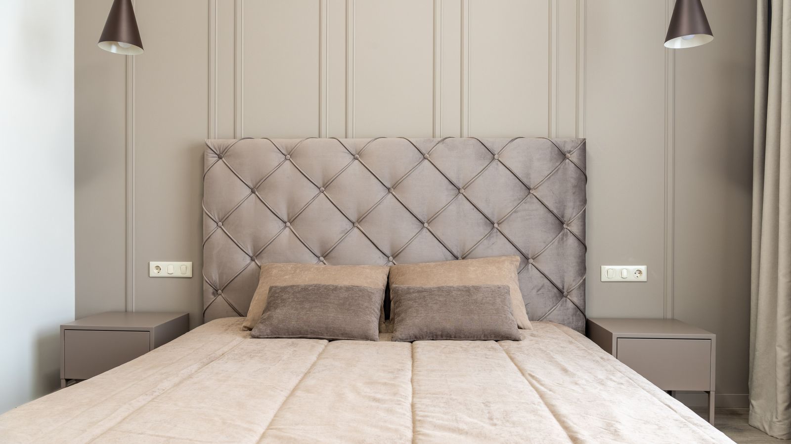 Bedroom interior showing a wooden headboard mounted on the wall above pillows