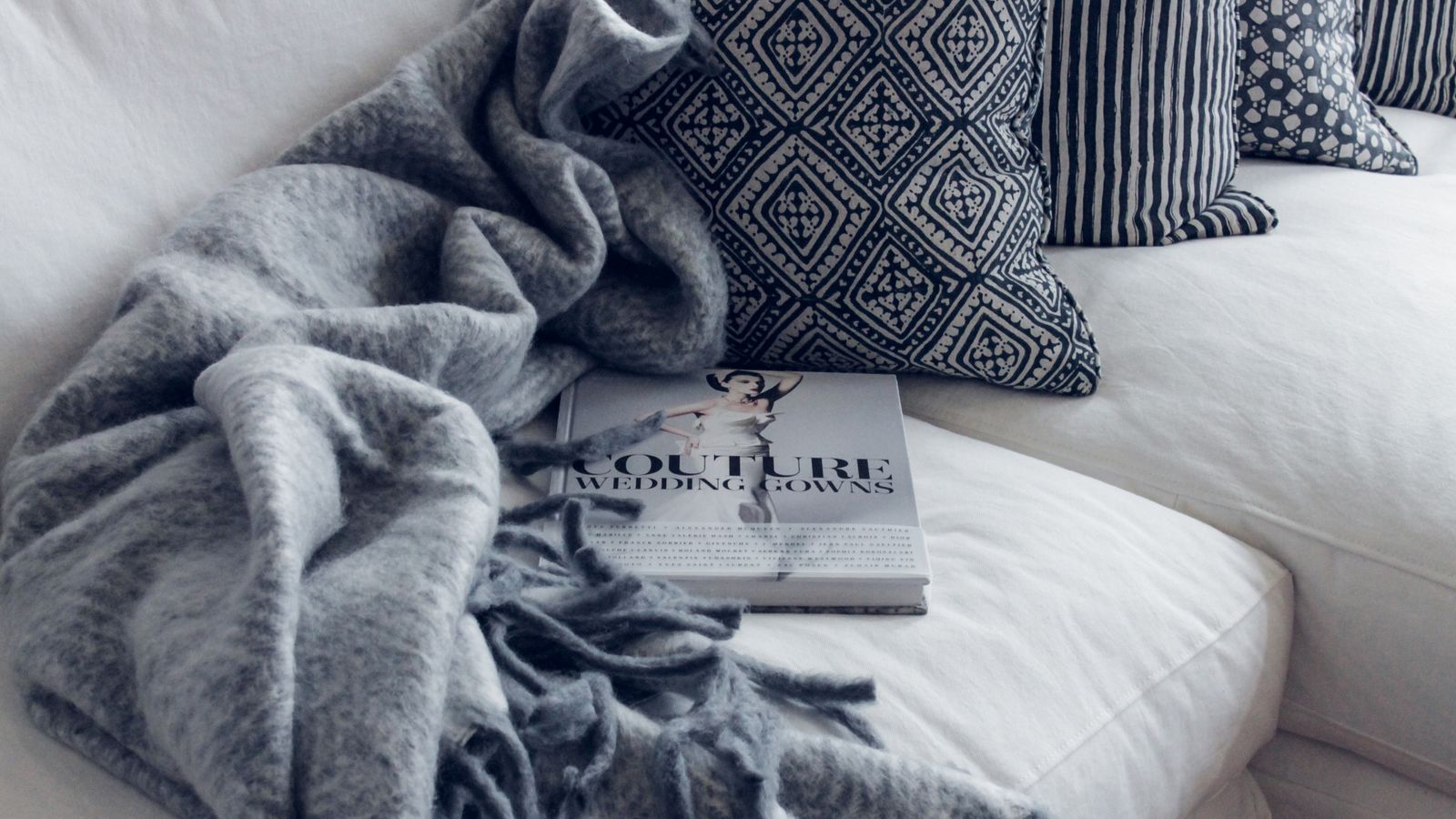 Cozy lightweight throw blanket draped over the foot of a bed for summer