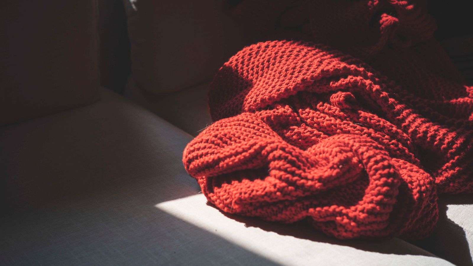 Close-up texture of a cotton waffle weave blanket folded neatly on a bed
