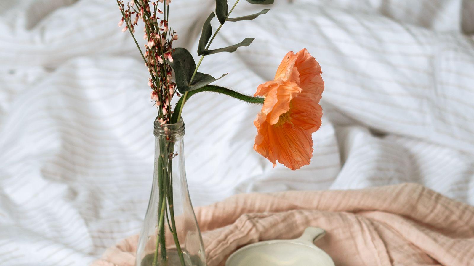 Crisp eucalyptus lyocell sheets neatly made on a bed in soft natural light