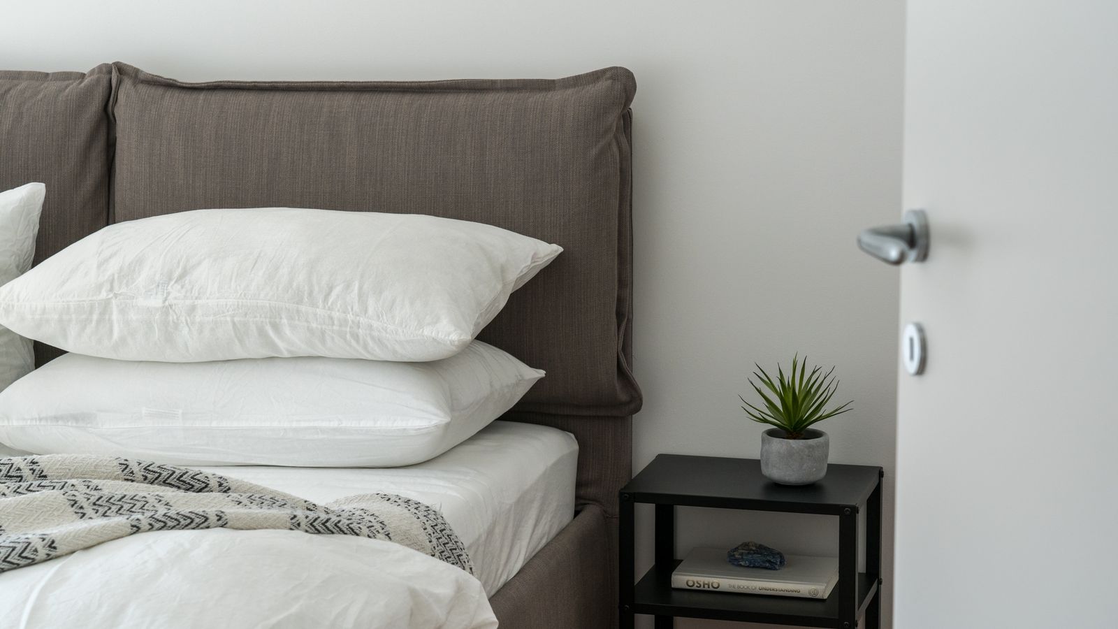 Cozy bedroom setup with layered eucalyptus sheets and soft throw blanket for temperature control
