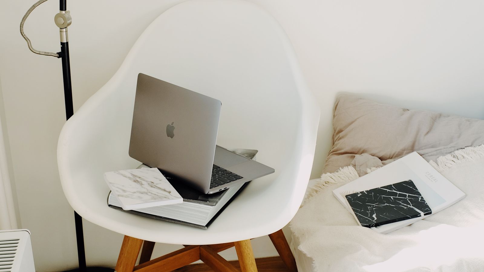 Cozy upholstered reading chair positioned in a bright bedroom corner