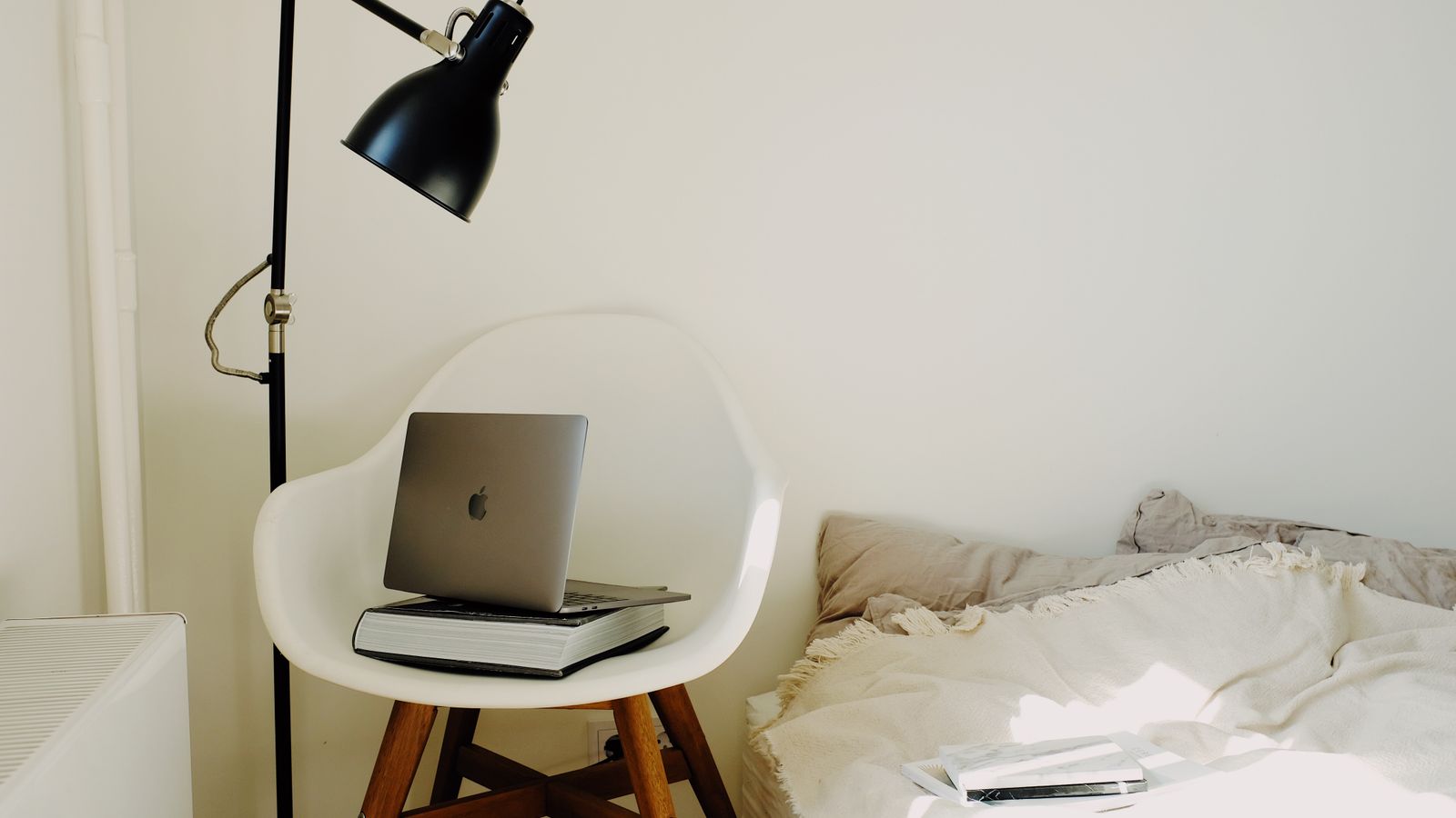 Reading nook corner with an armchair, side table, and bookshelf styling