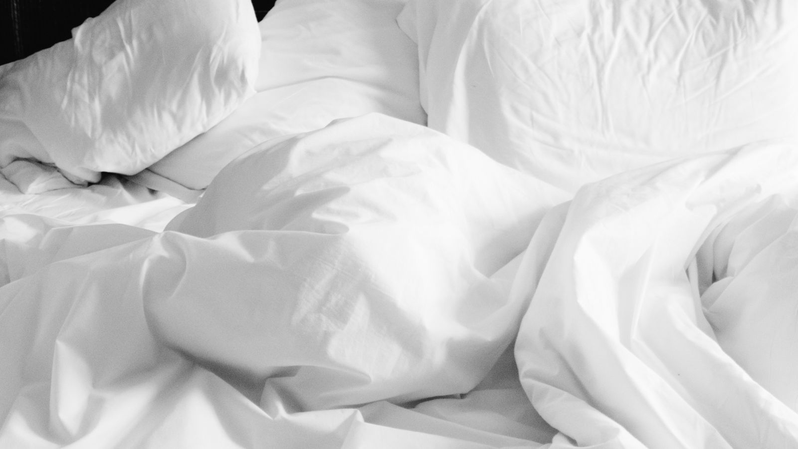 Neatly folded cooling comforter ready for storage in a breathable bag