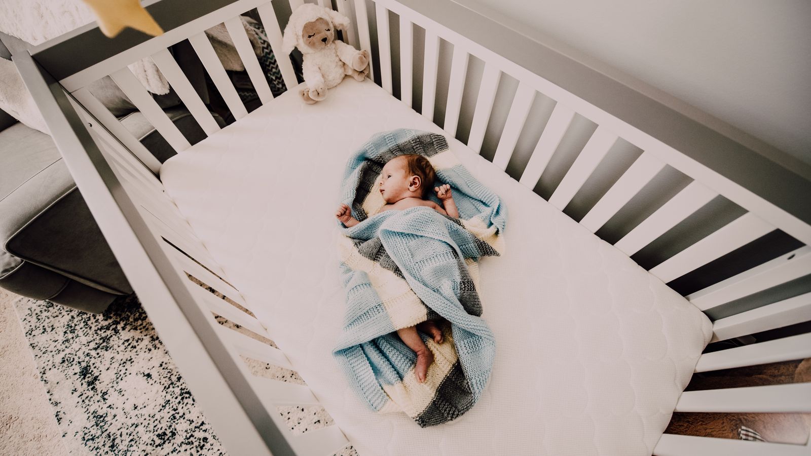 Clean folded baby bedding and laundry supplies for washing a mattress pad