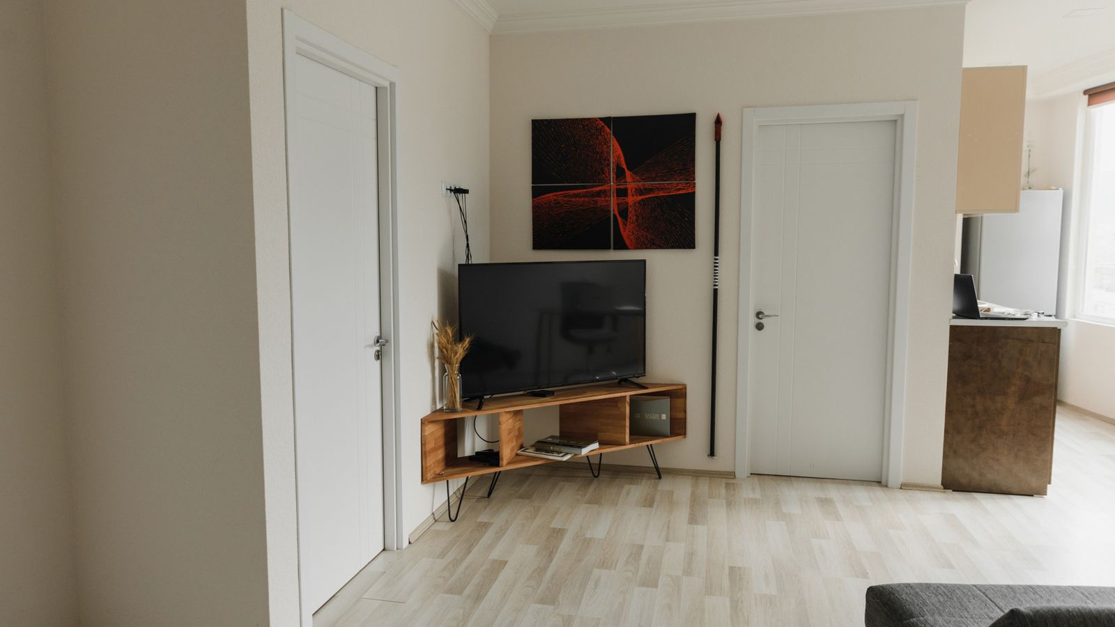 Modern TV stand with hidden cable management holding a mounted television