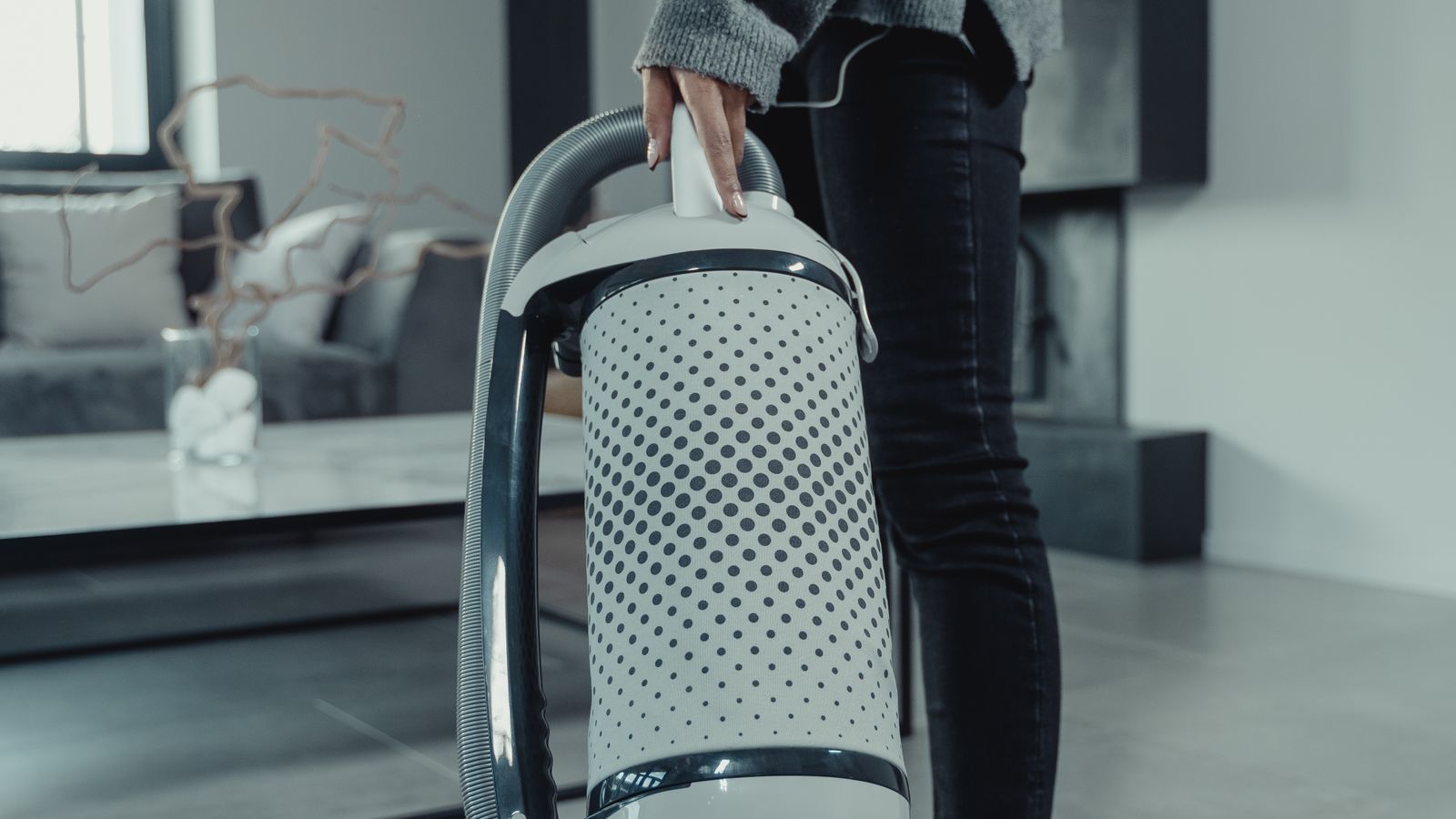 Close-up of a vacuum cleaner brush head being tested on a patterned rug