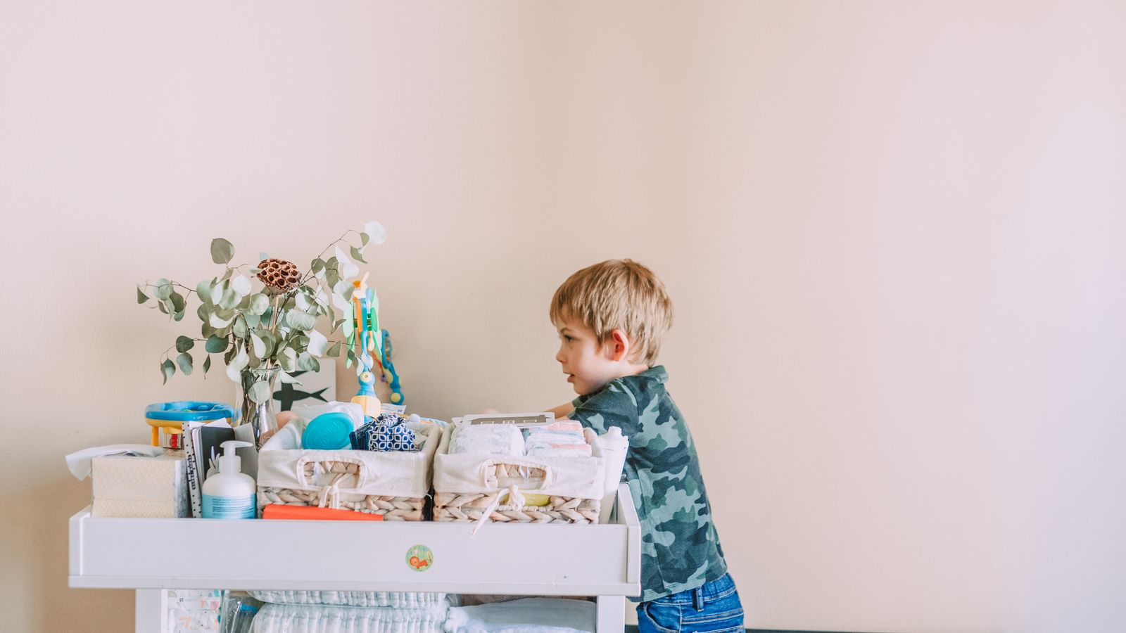Organized nursery dresser drawer with neatly folded baby clothes after cleaning