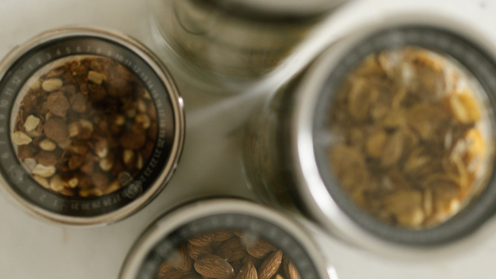 Glass kitchen canister filled with dry pantry staple sitting on a countertop