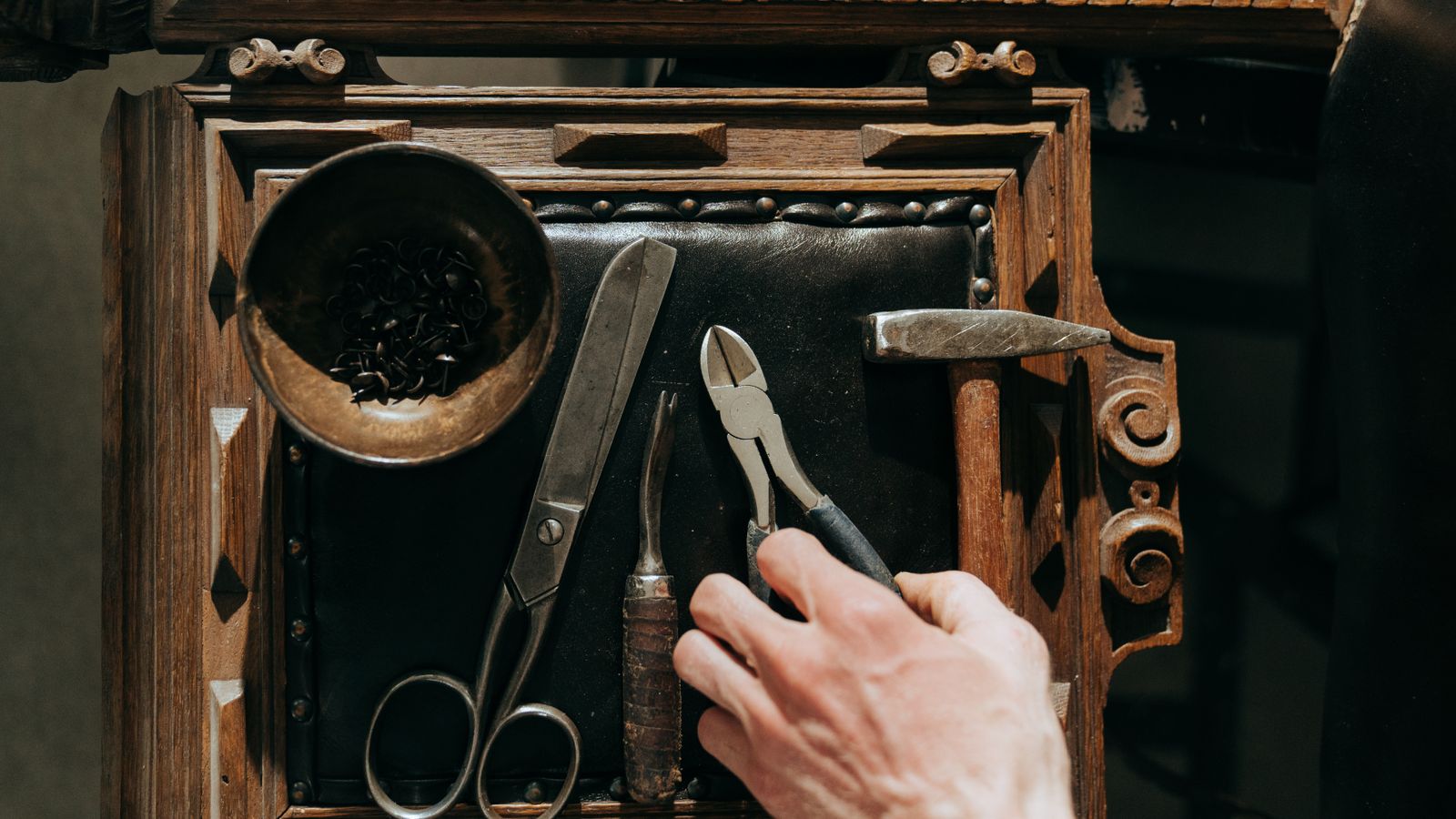 Close-up of leather repair spatulas and grain paper being wiped clean