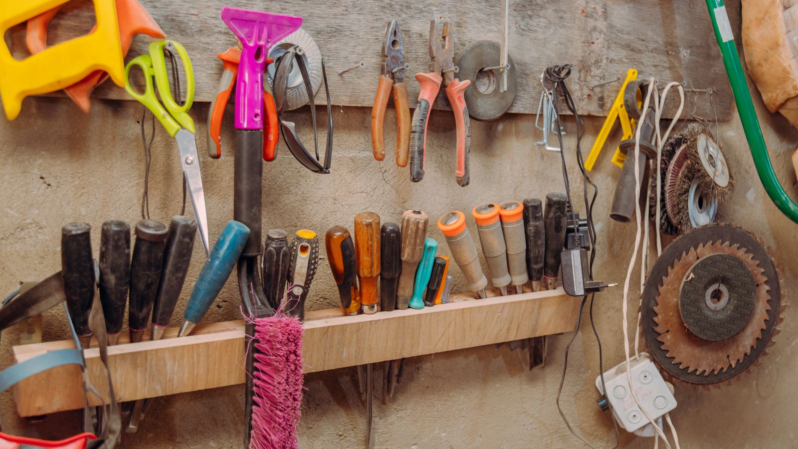 Wall-mounted tool storage with organized hand tools for furniture repair