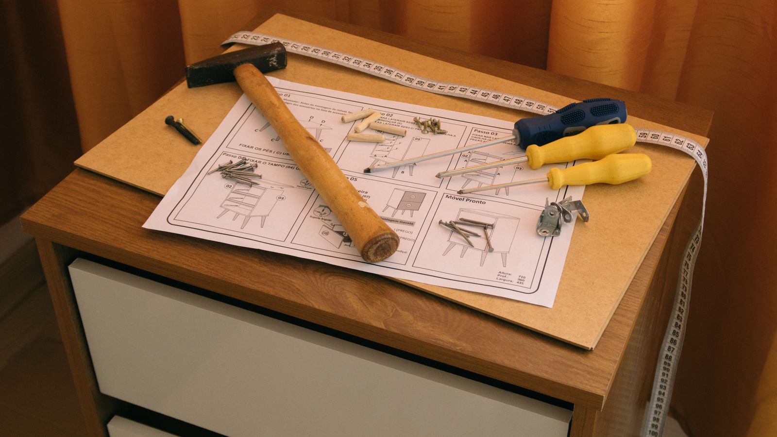 Furniture repair kit with tools and wood glue laid out on a workbench
