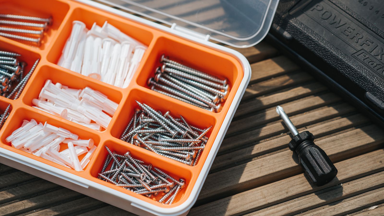 Close-up of wood clamps and screwdrivers used for furniture joint repair