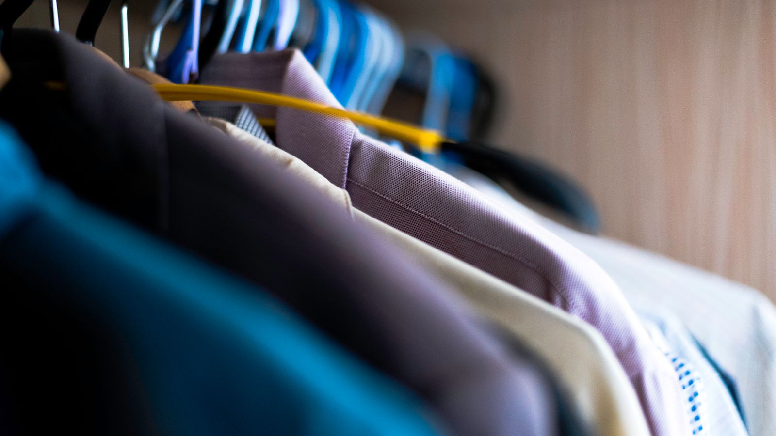 Wooden dresser drawers with folded clothing in a child's bedroom