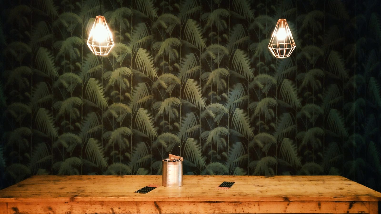 Dining room with patterned wallpaper and natural light setting a warm decor scheme