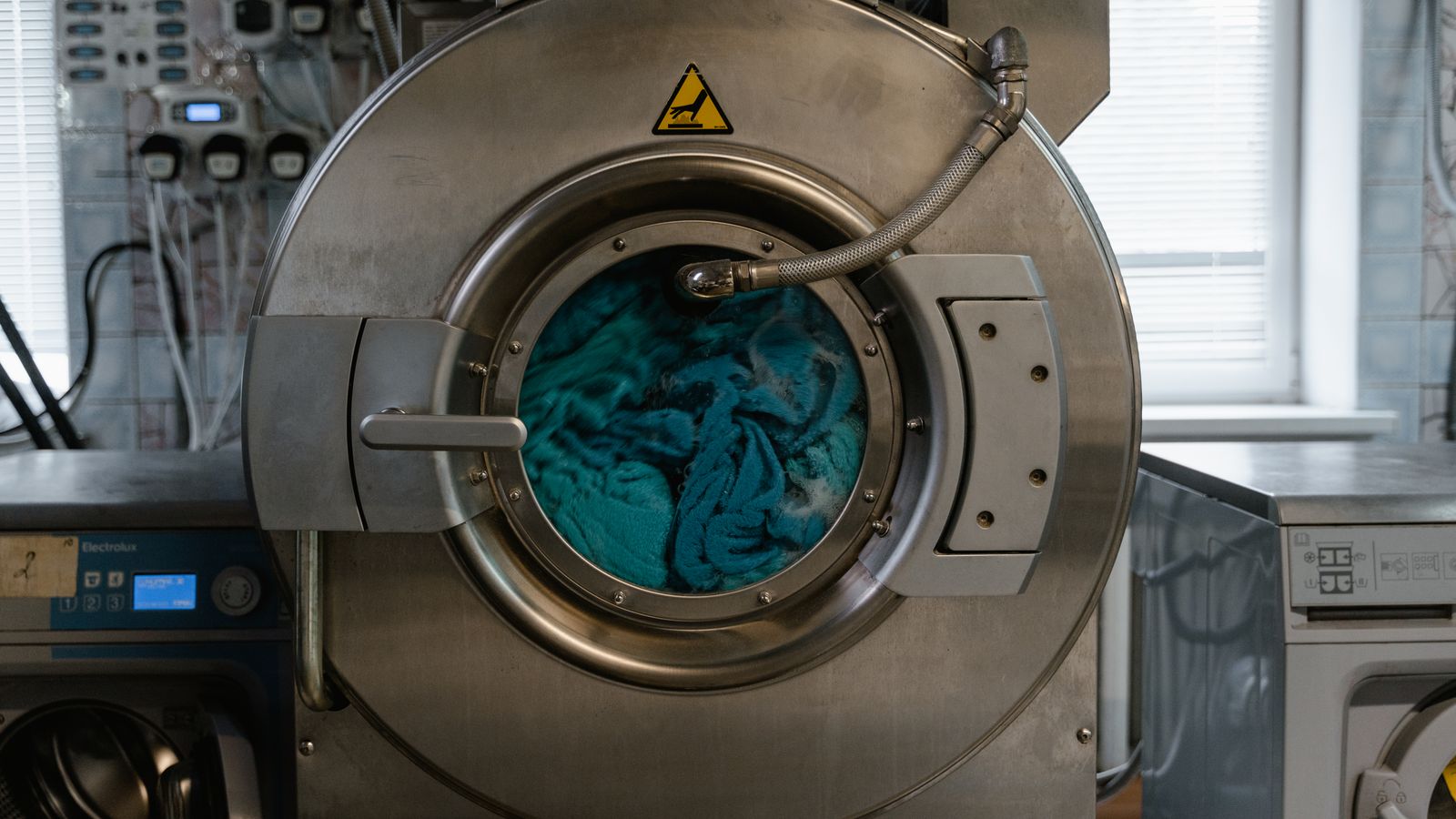 Compact washer dryer combo unit installed in a small apartment laundry closet