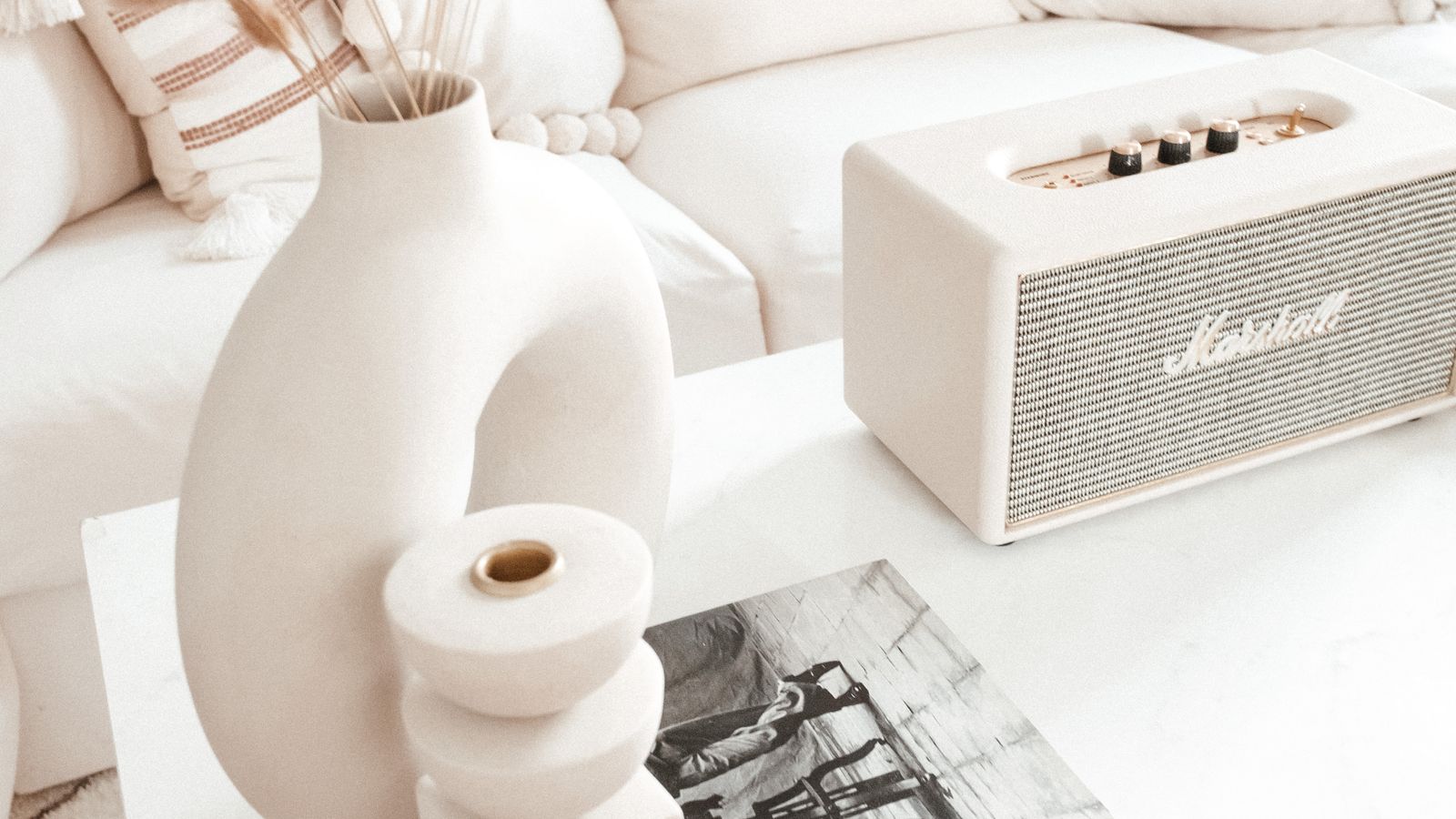 Upholstered ottoman used as a footrest and side table in a living room