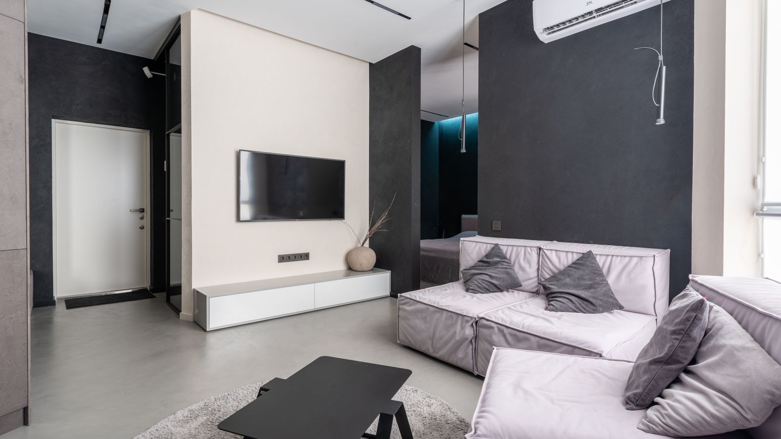 Wall-mounted mini split air conditioner indoor unit installed near the ceiling