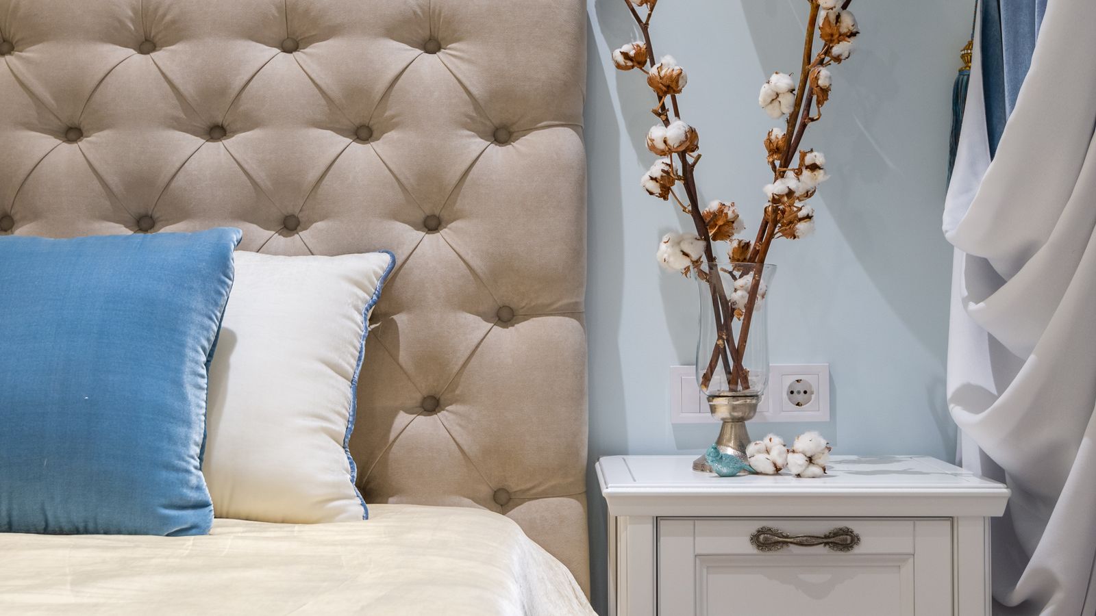 Close-up of bed frame legs fitted with risers for added under-bed storage clearance