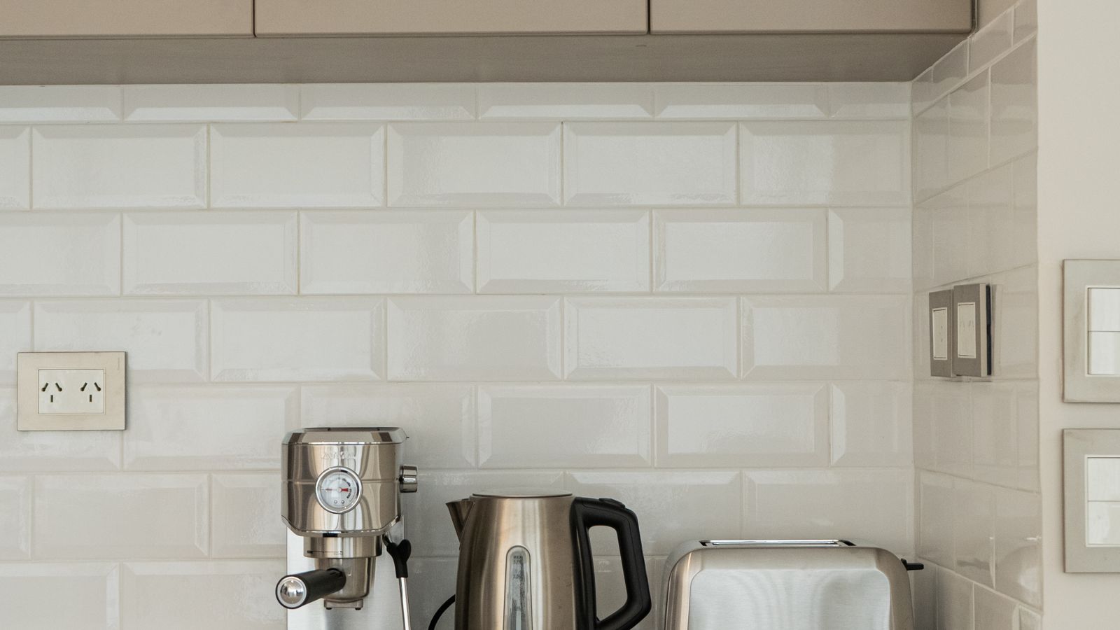 Modern kitchen counter organized with small appliances including a coffee maker