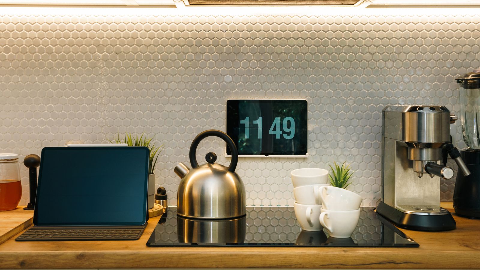 Organized kitchen counter zone with appliances and open cabinet storage nearby
