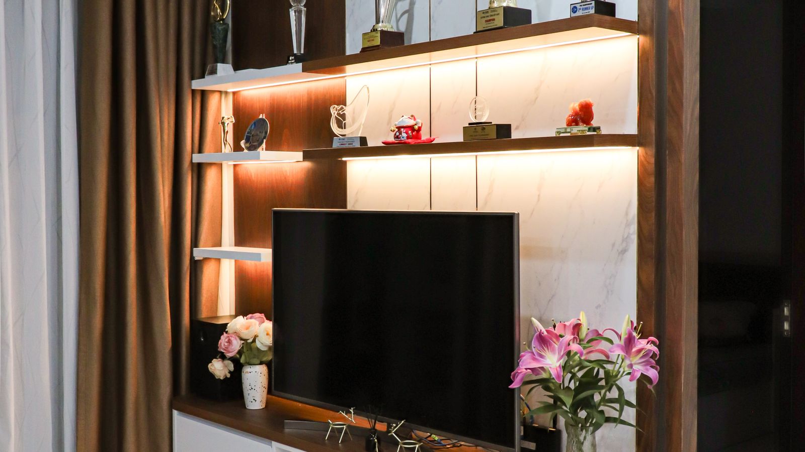 Modern living room with a tidy TV stand and stylish decor arrangement