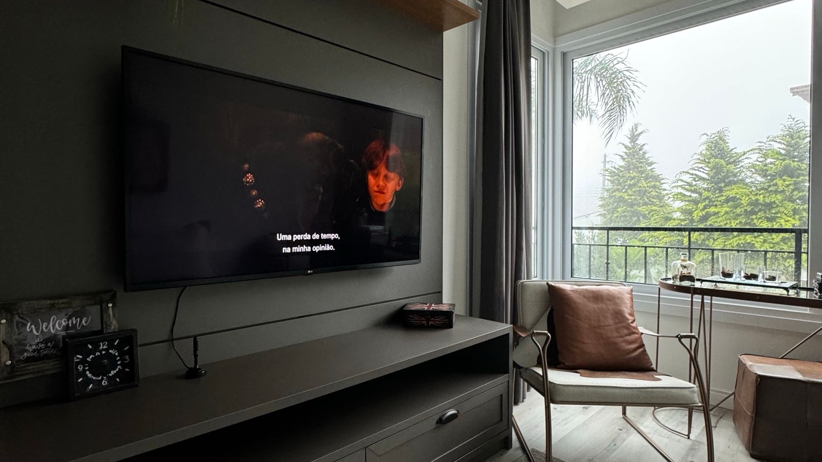 TV mounted above a low console with hidden cable routing in a modern living room