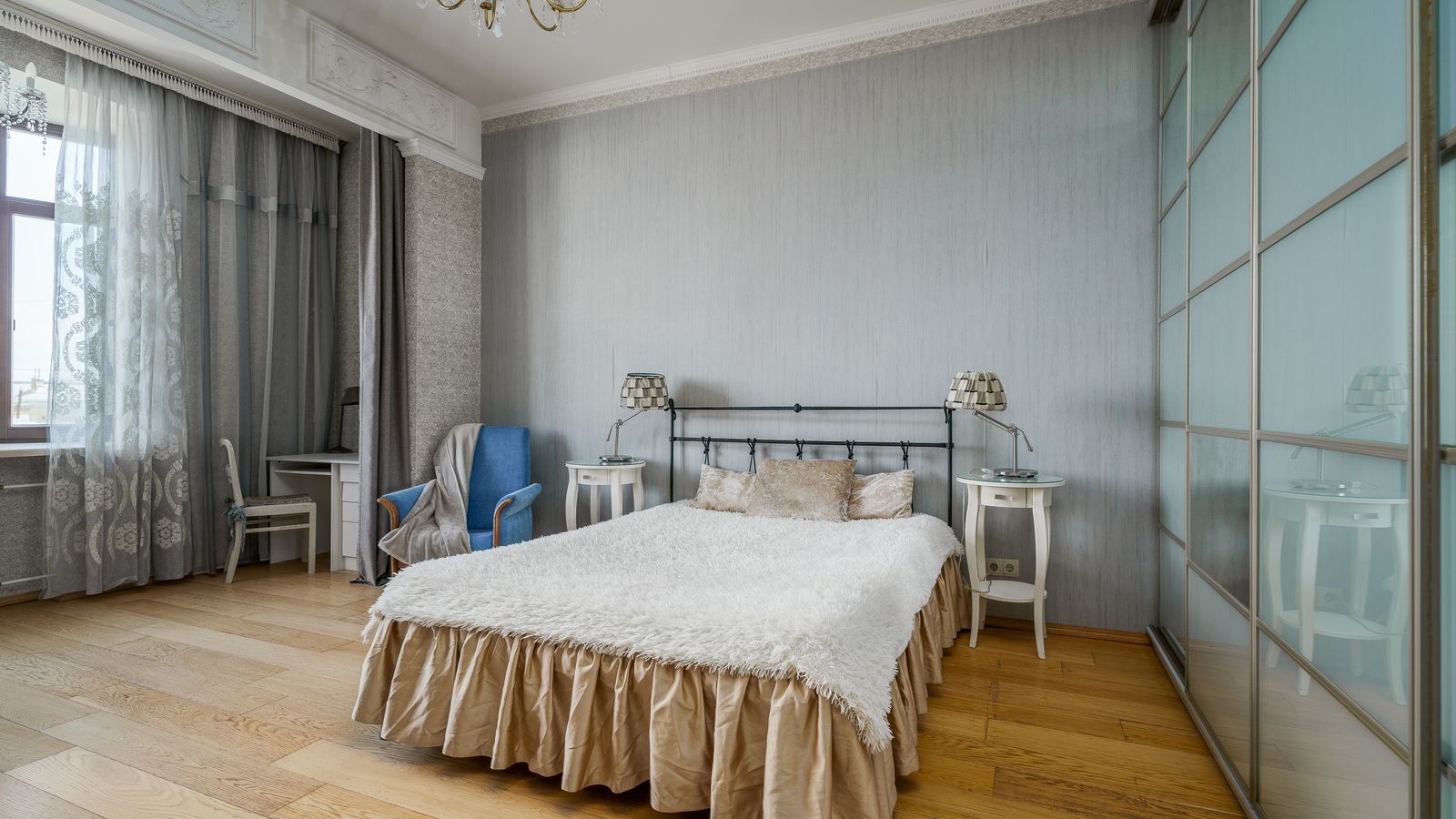 Light-colored bedroom interior showing how a neutral bed skirt blends with the floor