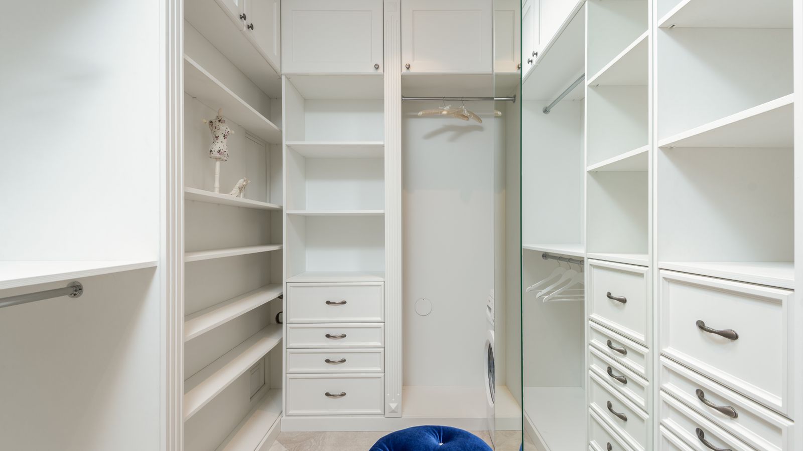Stacked storage bins used to organize folded clothes in a small closet