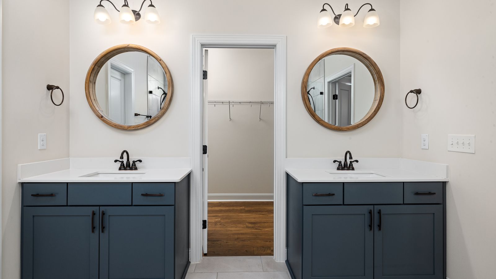 Modern bathroom with double sink vanity and large mirror above two basins