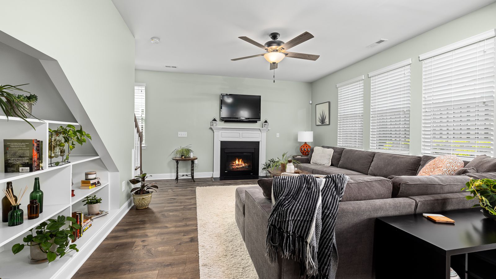 Cozy living room layout with sofa, coffee table, and TV setup