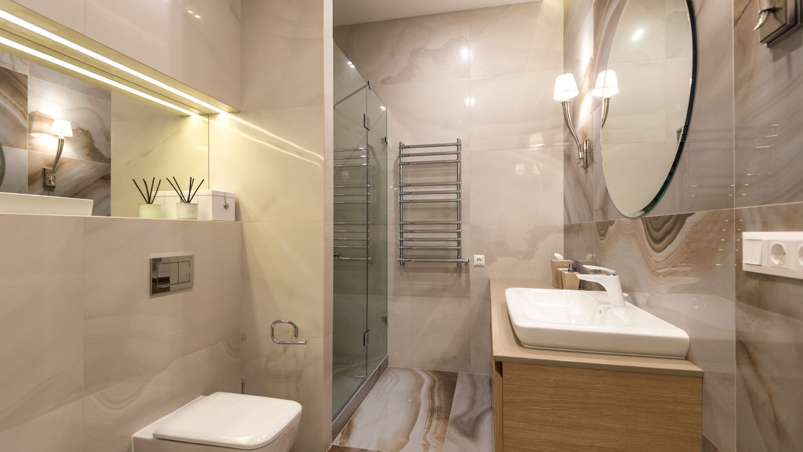 Modern bathroom with sink, toilet, and updated light fixtures for a budget renovation