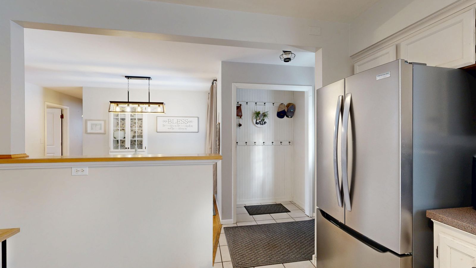 Modern kitchen with a stainless steel counter depth refrigerator built into cabinetry