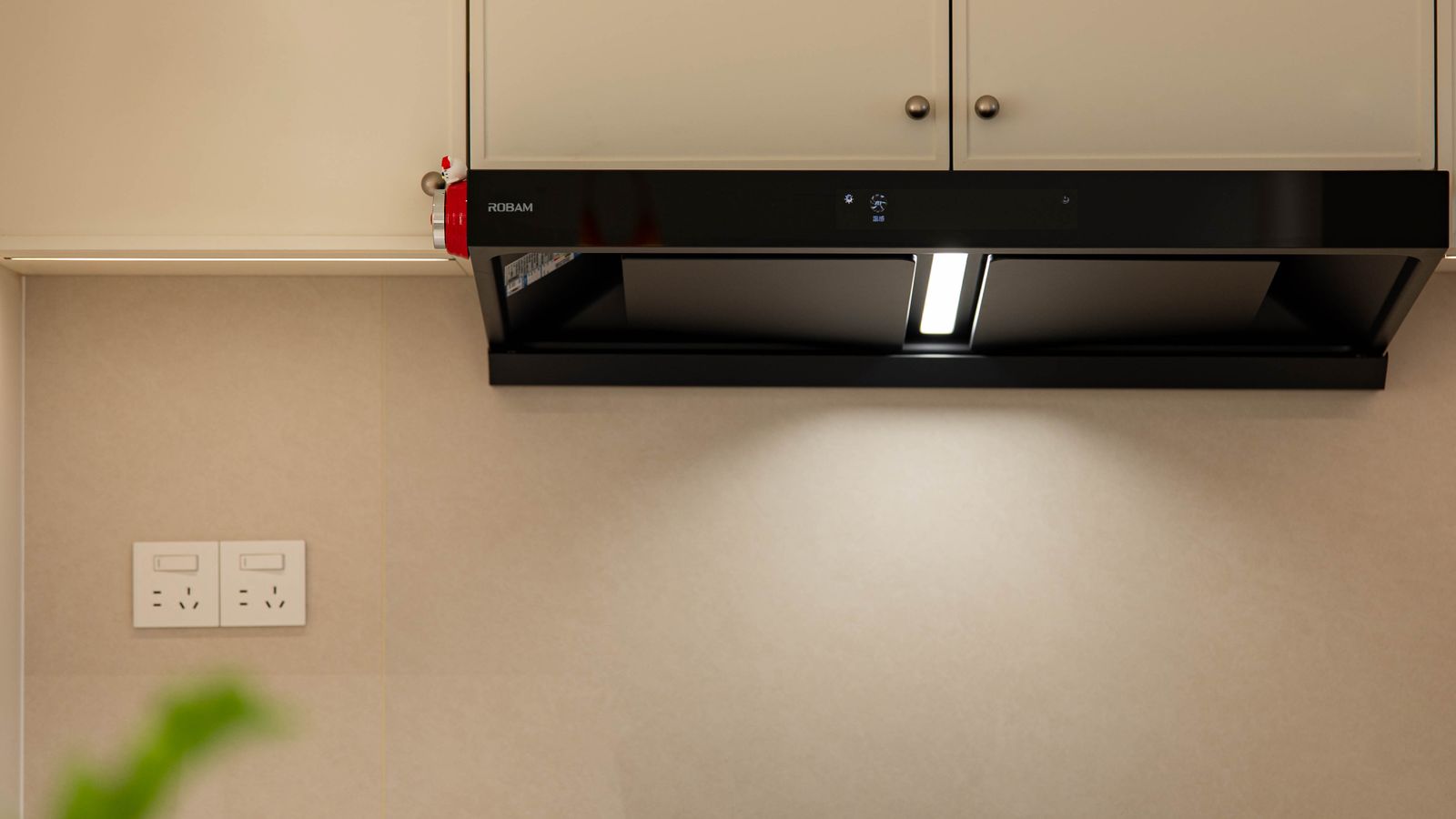 Stainless steel gas range with ventilation hood in a renovated kitchen