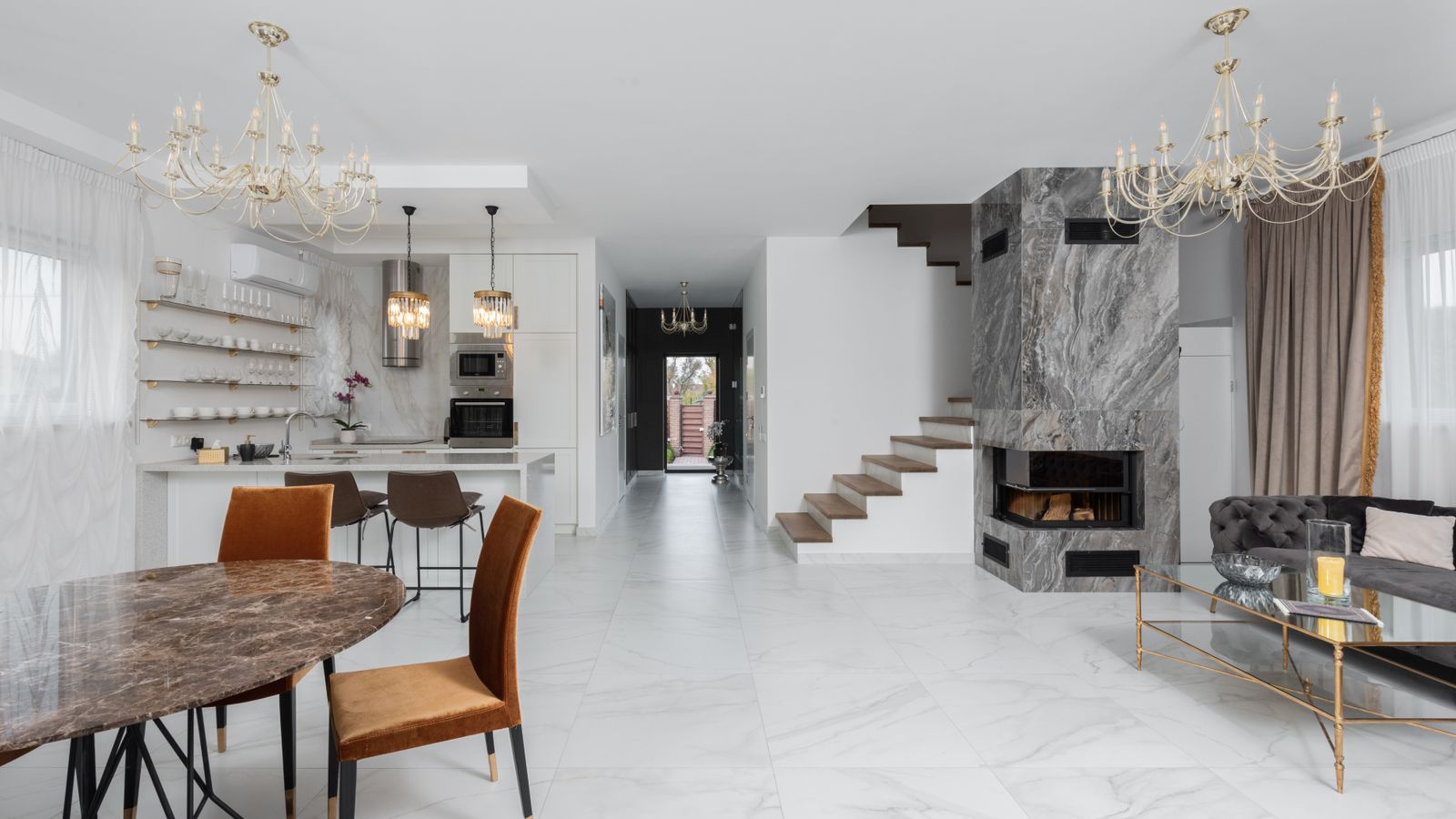 Honed marble coffee table with neutral tones next to a chaise lounge