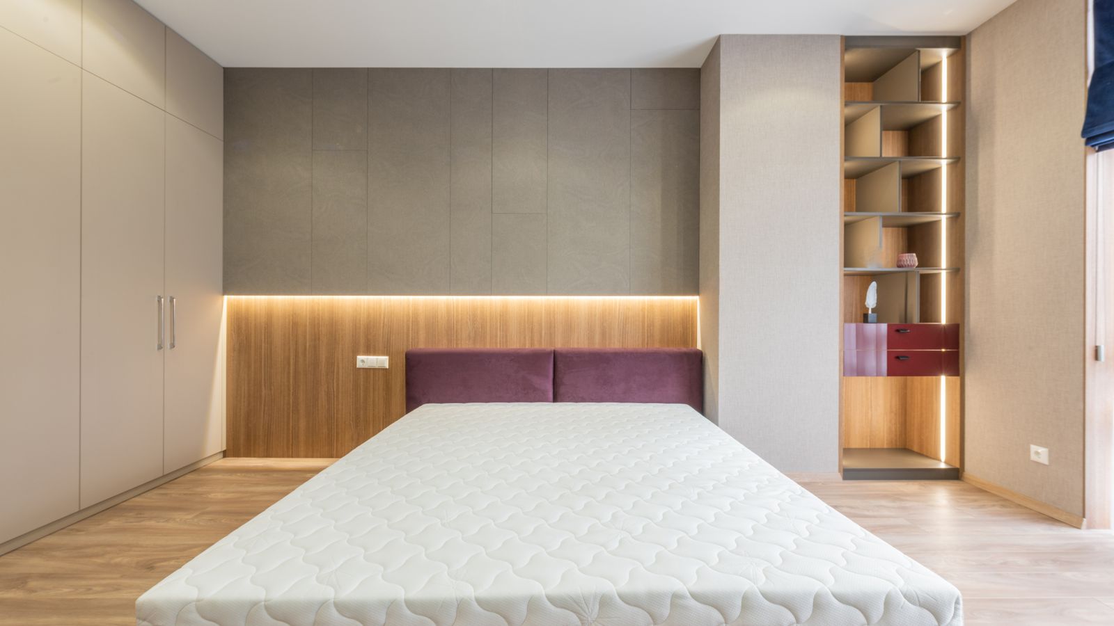 Sprinkling baking soda over a mattress surface before vacuuming for storage prep