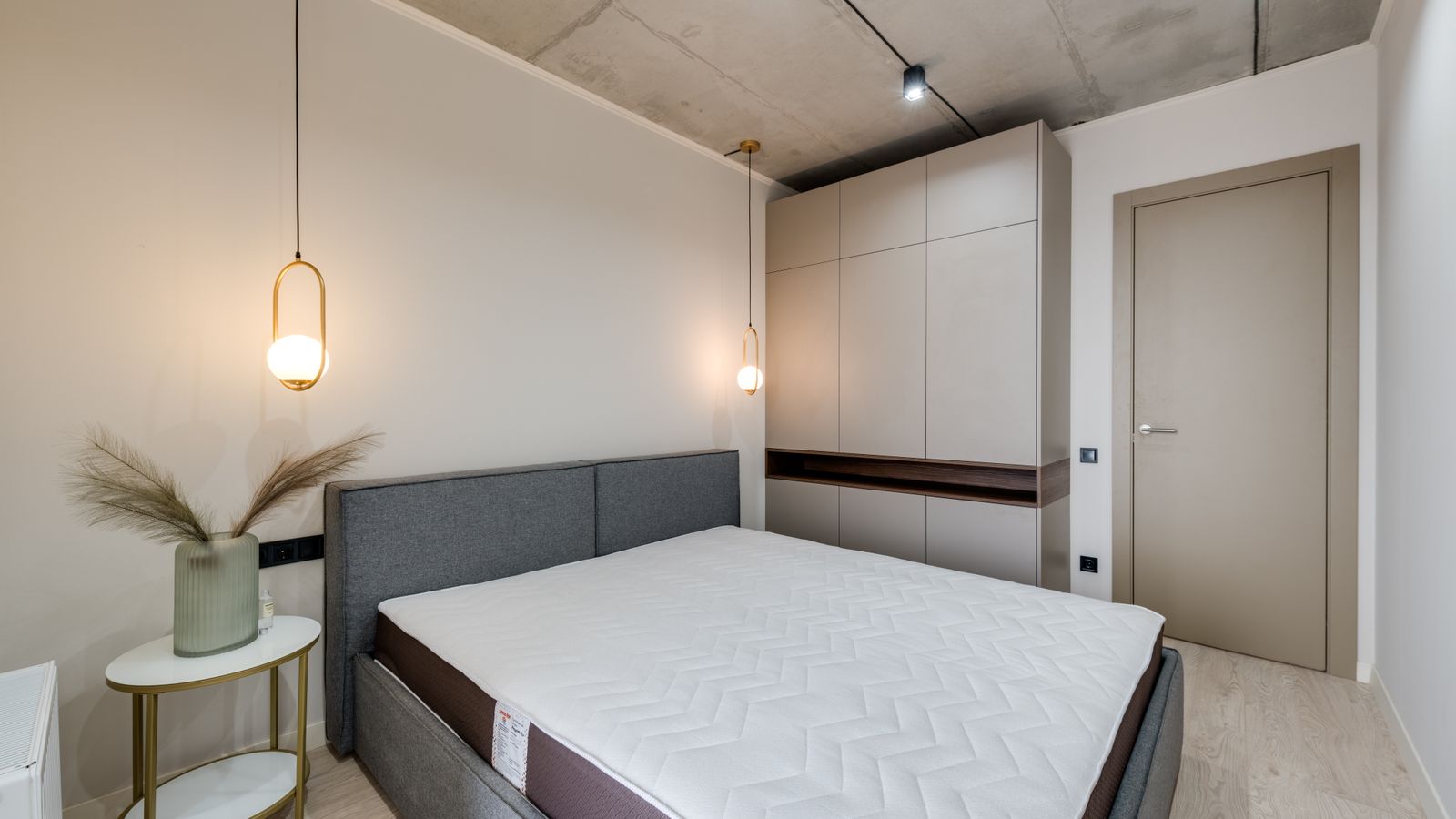 Mattress stored upright on wooden pallets in a climate-controlled storage space