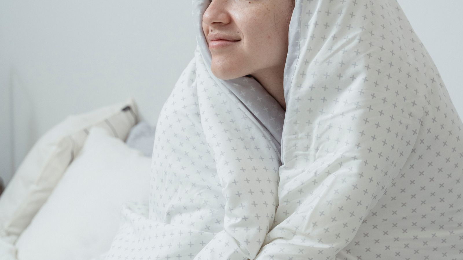 Neatly made bed with cooling comforter and breathable sheet set