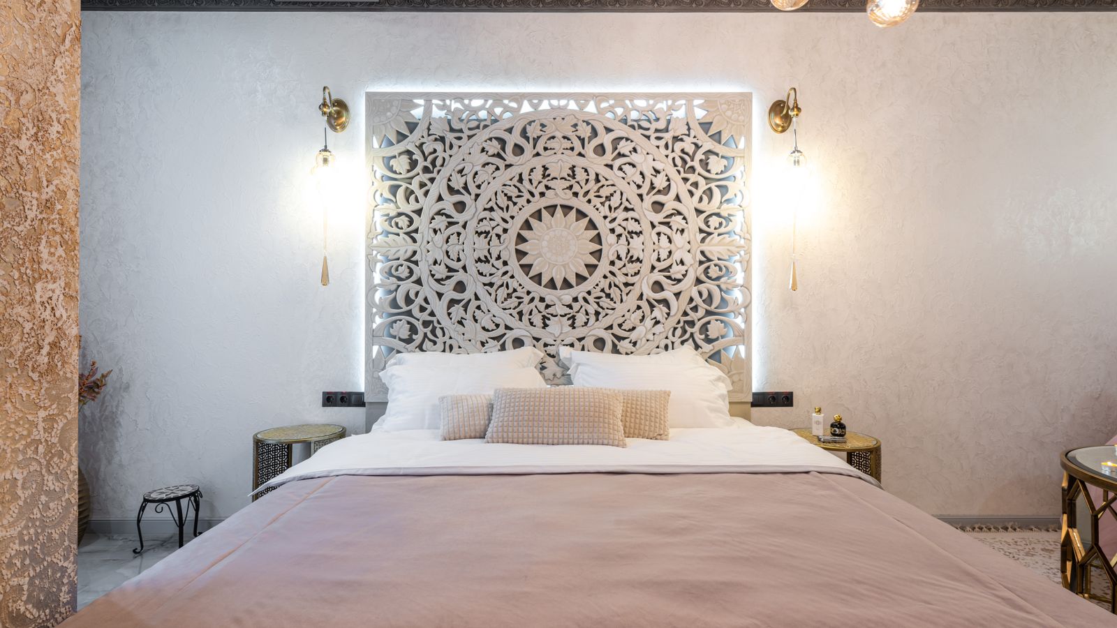 Beige upholstered headboard showing tufted fabric detail in a bedroom