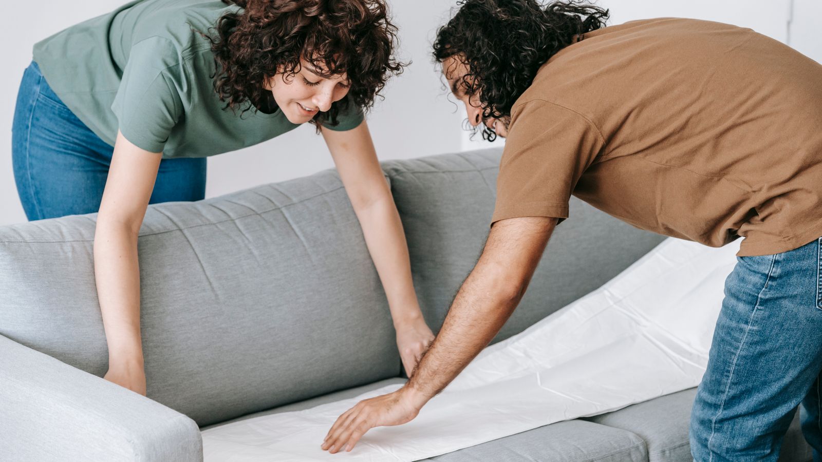 Neatly fitted fabric sofa cover on a living room sofa