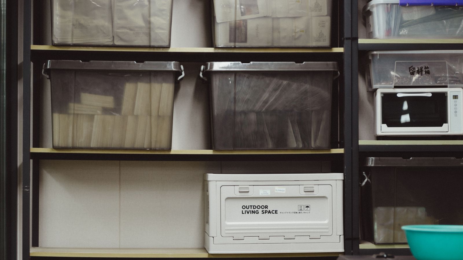 Organized storage room with plastic containers arranged on open shelving