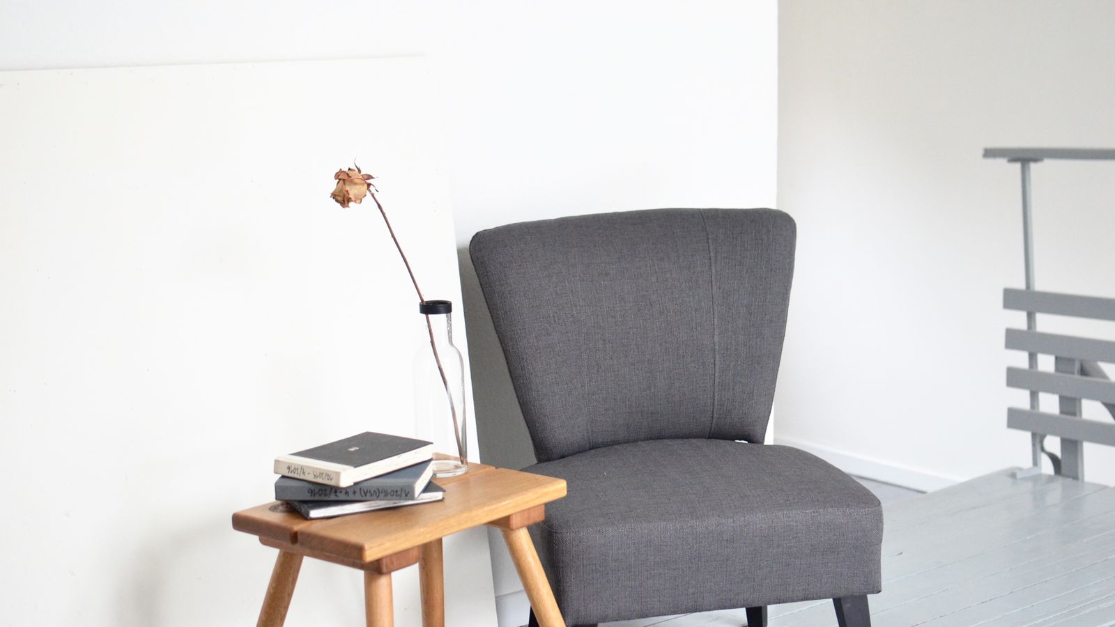 Upholstered bedroom armchair positioned near a window for reading