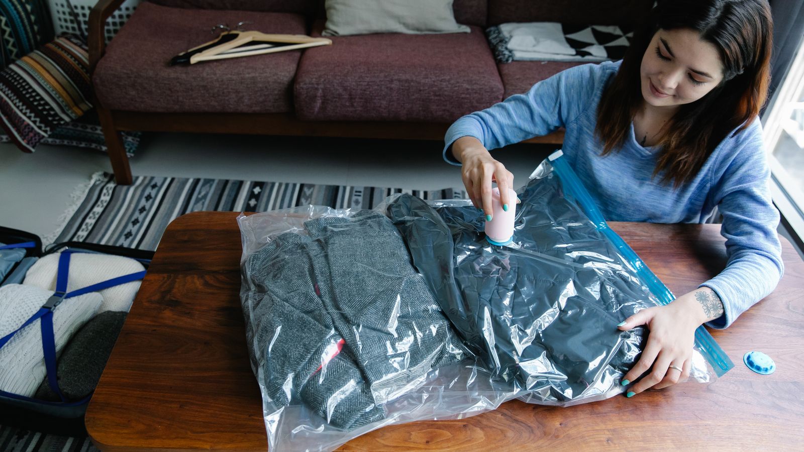 Vacuum storage bag compressing folded blankets and out-of-season clothing