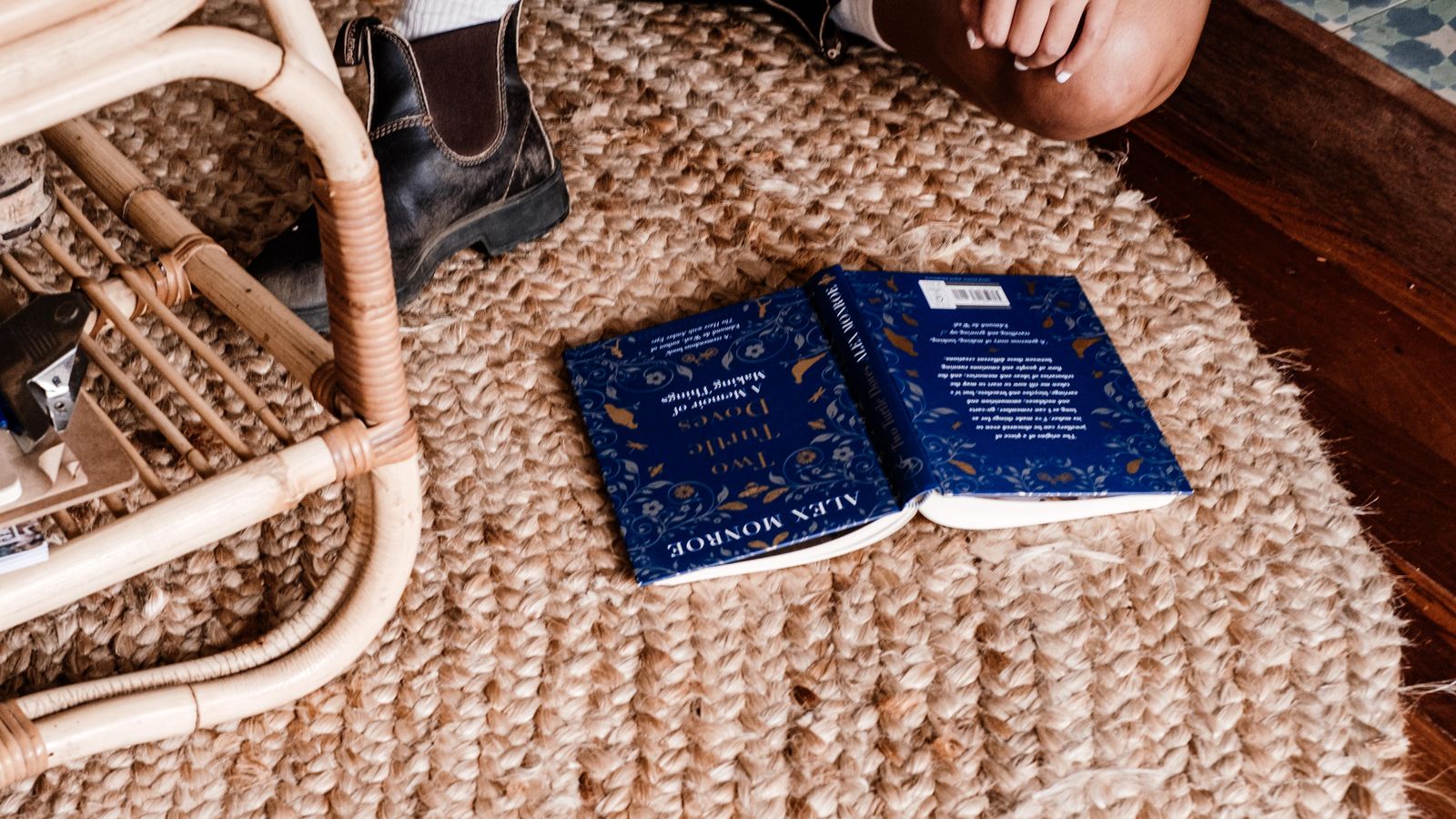Natural jute rug laid on a living room floor beside a wooden console table