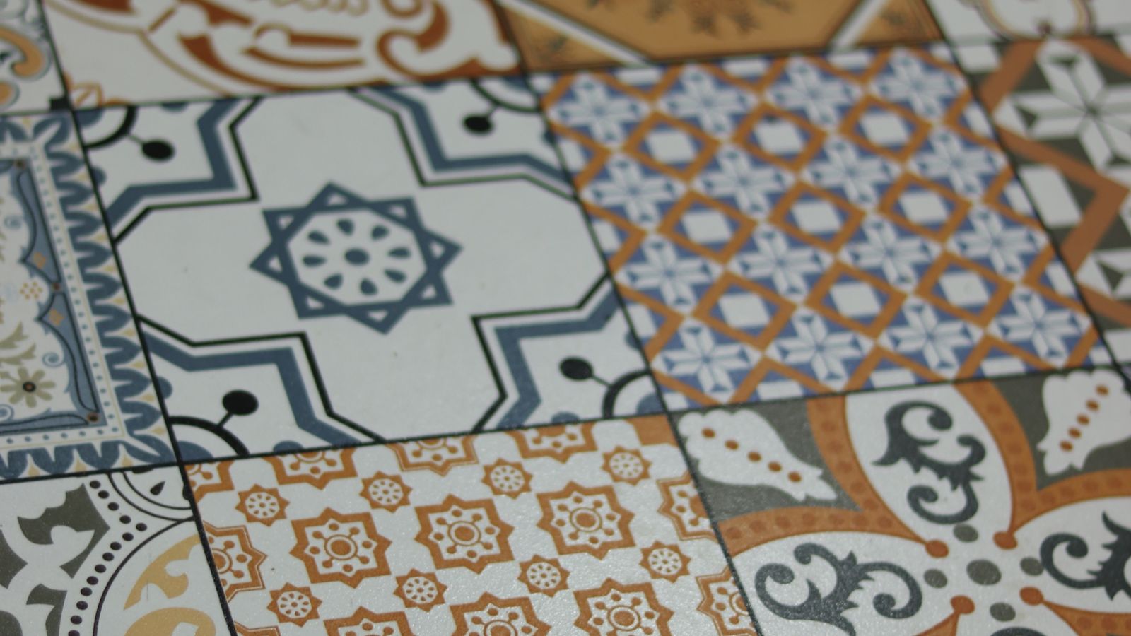 Colorful patterned peel and stick tile installed as a kitchen backsplash accent